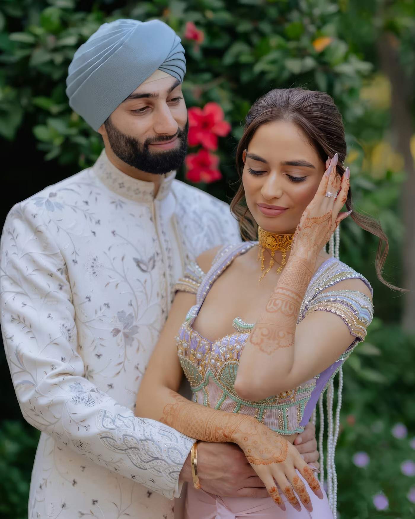 A Sikh couple in elegant wedding attire sharing a quiet, tender moment outdoors — representing the warmth, cultural pride and human connection at the heart of this matchmaking service